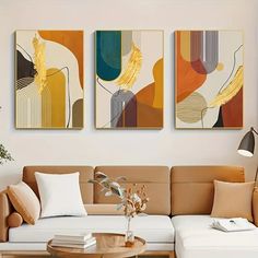 a living room with two paintings on the wall