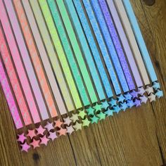 several different colored pencils lined up on top of each other with stars in the middle