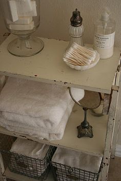 a shelf with towels and soaps on it