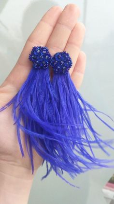 a pair of blue hair clips in someone's hand