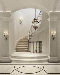 an elegant staircase with chandelier and marble floors