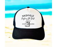 a black and white hat sitting on top of a sandy beach