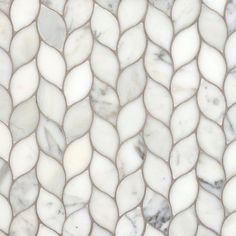 a close up view of a white and grey marble mosaic tile pattern with wavy lines