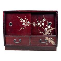 a wooden cabinet with two drawers and flowers painted on it