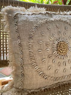 a decorative pillow on a wicker chair