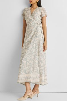 Unveil elegance with our 'Maxi Wrap Dress in Blue Florals,' featuring a relaxed fit and adorned with delicate blooms. This chic wrap dress, perfect for cool evenings or leisurely afternoons, offers both style and comfort. Embrace its versatile design, complemented by the convenience of pockets on both sides. Elevate your summer wardrobe with this trendy maxi dress, ideal for casual gatherings or a stylish day out. Wash in cold water or dry clean only Do not soak bleach or wring Line dry in shade Spring Garden Party Wrap Dress, Elegant Floral Print Wrap Maxi Dress, Flowy Wrap Dress For Spring, Elegant Floral Print Wrap Dress For Garden Party, Blue Floral Print Wrap Dress, Feminine Floral Print Wrap Dress For Brunch, Feminine Floral Wrap Dress For Brunch, Wrap Maxi Dress For Spring Daywear, Garden Party Floral Wrap Dress With Surplice Neckline