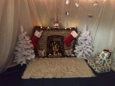 a fireplace decorated for christmas with stockings and presents