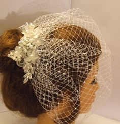 a doll with a veil and flowers on it's head is wearing a hair piece