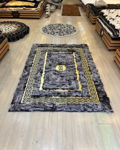 a room filled with lots of beds and rugs on top of hard wood flooring