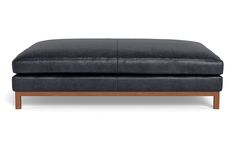 the footstool is made out of black leather