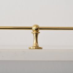 a golden handle on a white counter top