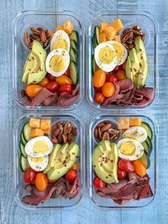 four plastic containers filled with different types of food