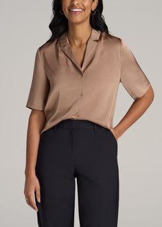 The Sophisticated Tall Women's Blouse Elegance in Every Thread Embrace elegance with our Notch Collar Satin Blouse for tall women. This hip-length, short sleeve tall women's blouse combines the luxurious feel of 100% polyester satin with a relaxed, yet sophisticated fit. The pre-washed fabric ensures shrinkage control for a consistent fit, while the self-fabric collar and button closure add a touch of class. Whether for a day at the office or a night out, this women's tall shirt is your go-to fo Elegant V-neck Shirt For Daywear, Elegant Half Sleeve Summer Shirt, Summer Formal V-neck Shirt, Formal V-neck Summer Shirt, Semi-formal Solid V-neck Top, Sleek Solid Color Summer Blouse, Semi-formal Short Sleeve Shirt For Spring, Fitted Semi-formal Tops With Collared Neckline, Fitted Collared Neckline Top For Semi-formal Occasions