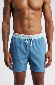 These classic swim trunks are made with quick-drying four-way-stretch fabric and built-in mesh compression shorts for comfort wherever the waves take you. 5 1/2" inseam; 23" leg opening; 11 1/2" front rise; 14 1/2" back rise (size Medium) Elastic/drawstring waist Side-seam pockets with mesh lining; back zip pocket Built-in mesh compression shorts UPF 50+ sun protection Four-way-stretch fabric 92% polyester, 8% spandex Machine wash, tumble dry Imported Blue Swimwear With Built-in Shorts For Surfing, Sporty Blue Swim Trunks With Built-in Shorts, Blue Athletic Shorts With Built-in Shorts For Water Sports, Blue Swimwear With Built-in Shorts For Sports, Nylon Swimwear With 4-way Stretch For Water Sports, Blue Athleisure Swimwear With Built-in Shorts, Blue Fitted Surfing Shorts, Fitted Blue Surfing Shorts, Sporty Blue Breathable Swim Trunks