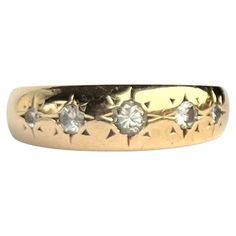 This gorgeous 18ct gold band holds five diamonds totalling 23pts. They are bright and have a lovely sparkle and are set in star settings. Ring Size: J 1/2 or 5 Band Width: 6mm Weight: 3.8g Star Setting, J 1, Vintage Fans, Mens Ring, Three Stone Rings, Gold Band, Three Stone, Gold Bands, Band Rings