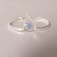 Blue Forget me not flower in  resin bracelet . Pressed flower jewelry . An elegant resin bracelet with real flower  Forget me not .This will be a special gift for a loved one, as ferns symbolize sincerity towards others. If you are giving someone a fern as a gift, you are giving them the hope that they will have confidence, shelters, wealth, and happiness. This is a great plant to give someone that you really care about. Charm size: 10 x10 mm (1/3 inch) Forget me not jewelry : https://www.etsy.c Personalized Flower-shaped Jewelry For Friendship, Personalized Flower-shaped Friendship Jewelry, Personalized Flower Jewelry For Friendship, Personalized Flower Shaped Friendship Jewelry, Resin Bracelets As Gifts, Adjustable Flower Bracelets With Pressed Flowers, Flower Charm Bracelets As Gifts, Resin Bangle Jewelry Gift, Resin Bangle Jewelry For Gifts