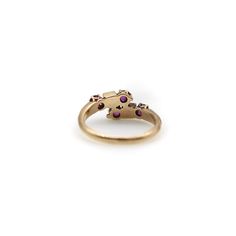 This is part of Chairish’s Fine Jewelry assortment.  A lovely Victorian ring with classic motifs that are feminine and delicate. This 14k gold band mirrors itself and meets at the centre in a cluster of gemstones—a milky white seed pearl flanked by two rubies. The gemstones are prong set, with the pearls housed in geometric squares that offset the femininity of the piece. The rubies are natural, which can be seen in the slight inclusions of the stones. They are very vibrant, and the craftsmanshi Elegant Multi-stone Open Birthstone Ring, Luxury Multi-stone Birthstone Ring For Formal Events, Elegant Cluster Amethyst Ring For Formal Occasions, Luxury Multi-stone Birthstone Ring For Formal Occasions, Elegant Formal Cluster Amethyst Ring, Elegant Multi-stone Ruby Open Ring, Elegant Multi-stone Cluster Birthstone Ring, Elegant Multi-stone Open Ruby Ring, Elegant Multi-stone Cluster Open Ring