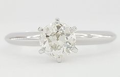 an oval cut diamond ring on a white background