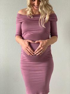 This off shoulder fold over maternity dress is versatility at its best! It is constructed of our premium stretch fabric, designed specifically with mama curves in mind. It hugs all the right places and still leaves a smooth, flattering appearance. Perfect for day or night and ideal throughout pregnancy and beyond!  Pictured in Mauve   #SexyMamaMaternity #maternitydresses #bumpstyle #dressthebump Stretch Off-shoulder Dress With Ruched Bodice, Fitted Draped Dress With Gathered Neckline, Chic Ruched Maternity Dress, Chic Maternity Ruched Midi Dress, Chic Ruched Maternity Midi Dress, Elegant Maternity Ruched Dress, Chic Fitted Ruched Maternity Dress, Elegant Maternity Dress With Ruched Detail, Fitted Pink Dress With Gathered Neckline