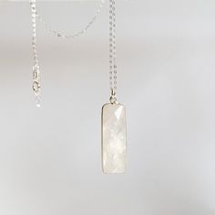 This bold rainbow moonstone pendant necklace features a gorgeous milky white elongated rectangle bezel set stone. Available in sterling silver or gold fill. -- pendant: 35mm x 10mm bezel frame: 22k gold over sterling silver necklace length: 18" available chain links: flattened cable and satellite available in: 14k Gold Filled and Sterling Silver Moonstone is a stone for new beginnings: inner strength & growth Moonstone Pendant Necklace, Rainbow Moonstone Pendant, Chain Links, Metal Chain Link, Milky White, Moonstone Pendant, Inner Strength, 22k Gold, Sterling Silver Necklace