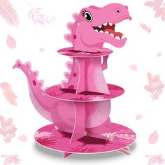 a pink dinosaur cake stand with an open mouth