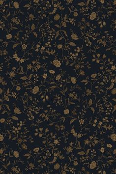 a black and gold wallpaper with flowers on it's side, in the dark