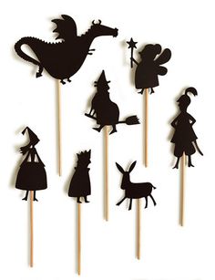 the silhouettes of animals and witches are on top of toothpicks with sticks sticking out of them