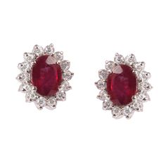 This Sterling Silver Earring features an Elegant Art With Natural Ruby Gemstone surrounded by tiny Zircon Gemstones. The cavity is made from genuine solid 925/92.5 Sterling silver and stamped as S925. This Jewelry is Lead free and finished with Rhodium to resist scratches and tarnish. ITEM DESCRIPTION Item Code: JAER131 Metal: 925/92.5 Sterling Silver Gemstone: Genuine Natural Ruby Faceted (Fissure filled) Gemstone Shape: Oval Gemstone Size: 6 x 8 MM Earring Length: 13 MM Earring width: 11 MM We Classic Red Halo Design Earrings, Classic Ruby Earrings With Halo Design, Ruby Earrings With Brilliant Cut For Anniversary, Classic Ruby Halo Design Earrings, White Gold Ruby Earrings With Halo Design, Classic Ruby Halo Earrings, Anniversary Ruby Earrings With Brilliant Cut, Brilliant Cut Ruby Round Earrings, Ruby Gemstone Round Earrings