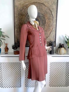 "☆ DESCRIPTION ☆ Beautiful vintage Biba skirt suit from 1969-70. Made from a tea rose colour sateen grosgrain fabric. The jacket is beautifully fitted with wide lapels, patch pockets, slim sleeves and a gathered feature on the back. Midi skirt is a subtle A-line shape. Both jacket and skirt are unlined so perfect for indoor wear.  ☆ CONDITION ☆ Excellent to very good vintage condition. Faults to note: there is a series of tiny dot-like pale marks in the fabric on the lower back and bottom (See last photo) and also some on the back of the right sleeve (see seventh photo). The original owner raised the hemline about 1.5 inches and I have left it \"as is\" since there is likely to be a visible line if lowered again. One of the buttons has the rim partly shear off (see eighth photo). The suit Retro Fitted Skirt Suit, Vintage Tailored Skirt Suit For Spring, Tailored Vintage Skirt Suit For Spring, Retro Fitted Skirt Suit For Spring, Turtleneck Suit, Biba Fashion, 60s Skirt, Vintage Skirt Suit, 70s Inspired Fashion