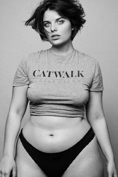 a black and white photo of a woman with her stomach exposed wearing a catwalk t - shirt