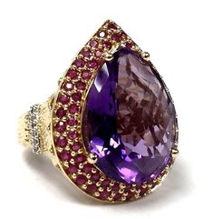 LARGE 14K GOLD 13.25 CTS. PEAR SHAPE AMETHYST, PAVÉ RUBY & DIAMOND COCKTAIL RING This beautiful cocktail ring features a large pear-shape amethyst set in 14 karat gold, framed by a double row of pavé rubies. A row of pavé diamonds are set across the shoulders of the ring. The ring has a pierced gallery, as well as a bark finish on the shoulders. Inside the ring is signed and hallmarked "14K SF".  Item Details Metal: 14K Gold  Gender: Ladies'  Ring Size: 6  Width at Top: 28mm  Width at Shank: 3mm  Hallmarks: "14K SF"  Total Weight: 11.1 grams (7.2 dwts)  Gemstone Details Gemstone: Amethyst Quantity: 1 Cut: Pear Shape Color: Purple Clarity: Eye Clean Carat Weight:(approximate) 13.25 carats  Gemstone: Ruby Quantity: 65 Cut: Round Color: Purplish Red Clarity: Slightly Included Carat Total Weig Luxury Pear-shaped Ruby Ring For Formal Occasions, Purple Ruby Ring For Formal Occasions, Formal Pear-shaped Amethyst Ring With Prong Setting, Luxury Purple Rings For Party, Luxury Purple Party Rings, Formal Teardrop Ruby Ring In Fine Jewelry Style, Formal Teardrop Amethyst Ring In Fine Jewelry Style, Formal Teardrop Multi-stone Ring, Formal Teardrop Ruby Ring Fine Jewelry