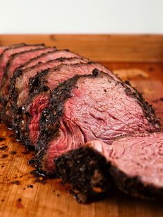 sliced steak on wooden cutting board ready to eat