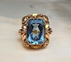 1950s Vintage German blue spinel ring, US size 7 1/4, 14k gold (585), handmade mid-century ladies ring, Art Deco, with a beautiful blue stone, the stone moves slightly (rattling), but it has been thoroughly checked by a jeweler and is secure; it won't fall out. A nice heft of the 6.7 grams of gold, would make a nice gift! Material: 14k gold (585 gold), blue spinel (sy) Total weight: 6.7 g US Size: approx. 7 1/4 (EU 56) Art Deco Topaz Ring With Center Stone, Antique Engraved Yellow Gold Ring With Gemstone, Heirloom 14k Gold Topaz Ring With Diamond Cut, Vintage Sapphire Ring With Diamond Cut For Collectibles, Vintage Sapphire Ring With Diamond Cut For Collectors, Antique Gemstone Cluster Ring For Formal Occasions, Art Deco Topaz Ring With Center Stone For Anniversary, Antique Formal Cluster Ring With Gemstone, Art Deco 14k Gold Topaz Ring For Formal Occasions