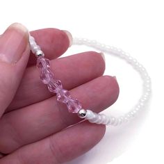 Dainty and delicate plain anklet with 4mm opaque white glass seed beads and the prettiest little bicone shape pale pink glass beads. Very feminine design! Elevate your summer style with our gorgeous seed bead anklets. Whether you're hitting the beach or strolling through the city, our anklets are the perfect accessory. They are lightweight and allergy friendly, and so comfortable you can wear them all day. We offer lots of sizes from to fit everyone, from Child/XS 8 inches all the way up to plus size 4XL 15 inches. Cheap Pink Round Beads Anklets, Bead Anklets, Seed Bead Anklet, Bead Anklet, Elastic Thread, Beaded Anklets, Allergy Friendly, All The Way Up, Glass Seed Beads