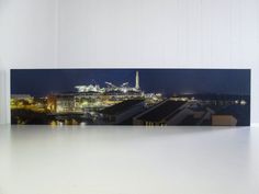 an image of a city at night taken from the top of a building with lights on