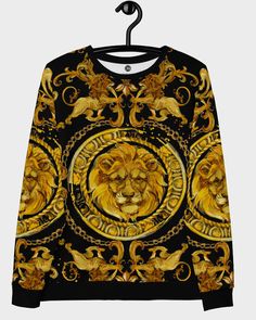 Rococo Lion Sweatshirt Luxe, ornamental Baroque lions sweatshirt. Athleisure gets couture treatment in this black and gold designer barococo lion sweatshirt. Elaborate golden accents and swirls pop on a crisp black background. Soft, flowing fabric with a soft sheen and a brushed fleece lining makes this a medium weight sweatshirt that can be comfortably layered or worn alone.  Our Baroque Lion sweatshirt is designed with a unisex fit.   Designed and sewn in the USA.  • 70% polyester, 27% cotton, Black And White Lion, Quatrefoil Pattern, Flowing Fabric, White Lion, Tiger T Shirt, Tiger Stripes, Ugly Sweater, Rococo, Italian Fashion