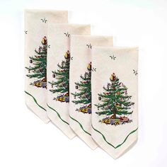 four christmas tree kitchen towels hanging on a wall