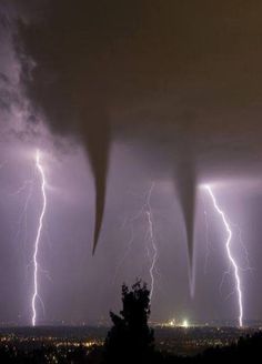 lightning strikes over the city at night time