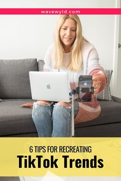 a woman sitting on a couch with her laptop and cell phone in front of her