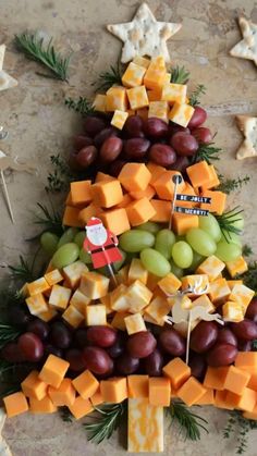 a christmas tree made out of cheese and grapes