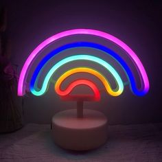 a neon light sculpture on top of a white table