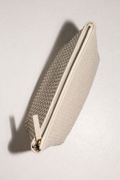 Woven leather pouche for all of your traveling needs. Inner pocket and zip closure Doubles as a clutch. Measures 12" x 7" x 4". Fabric is 100% leather. On-the-go Rectangular Soft Leather Clutch, Chic Travel Clutch With Zipper Closure, Textured Leather Pouch Clutch, Luxury Beige Clutch For Travel, Chic Travel Clutch With Zipper Pocket, Luxury Leather Cosmetic Bag With Zipper Closure, Versatile Leather Pouch Clutch, On-the-go Clutch With Zipper Closure, Leather Clutch With Zipper Closure For Travel