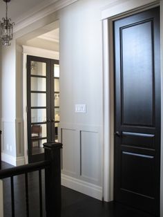 an image of a hallway with black doors