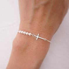 SOLID STERLING SILVER - HEIRLOOM QUALITY This lovingly hand-made bracelet is crafted using a solid sterling silver cross that measures just under 3/4 inch long. A row of 5 tiny crystal pearls come in your choice of 5 colors. The sturdy sterling silver chain and lobster clasp make this a durable bracelet. Comes in a gift box. I add a 1 inch extension chain to the end of the bracelet so it can grow with the child and is adjustable.  SIZING - IMPORTANT: To determine bracelet size, measure snugly ar Bracelet With Pearls, Silver Cross Bracelet, Girls Bracelet, Pearl Bracelet Wedding, First Communion Gifts, Pretty Jewelry, Bridesmaid Bracelet, Long A, Pretty Bracelets