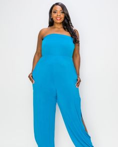 This strapless jumpsuit adds pizzazz to your casual wear wardrobe, the full legs have slits on the sides and finish with a ribbed cuff. Wear this stretchy jumpsuit for a night out, poolside party, and even as a beachy coverup. Perfect for the summer, this strapless plus-size jumpsuit can be worn with heels for a night out, or flip-flops to the beach. L I V D Lillian Sleeveless Jumpsuit | Turquoise | Dresses | Materials & Care Instructions: ['95% Polyester, 5% Spandex', 'Machine wash cold', 'Made Blue Stretch Strapless Jumpsuit For Spring, Blue Strapless Stretch Jumpsuit For Spring, Trendy Blue Strapless Jumpsuits And Rompers, Blue Stretch Strapless Jumpsuit For Summer, Blue Strapless Stretch Jumpsuit For Summer, Strapless Jumpsuits And Rompers For Summer Loungewear, Chic Strapless Jumpsuit For Loungewear, Spring Strapless Jumpsuit For Loungewear, Summer Strapless Stretch Jumpsuit For Loungewear