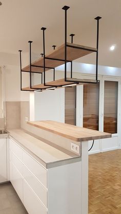 an empty kitchen with white cabinets and wood flooring is pictured in this image, there are no people or objects on the counter