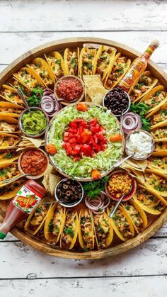 a platter filled with lots of different types of food and condiments on it