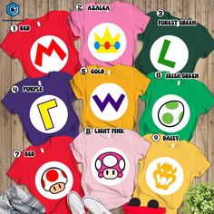 an image of some t - shirts that are on the floor with mario and luigi