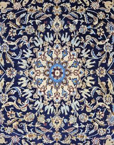 an intricately designed rug with blue and gold colors is shown in this close up photo