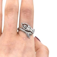 This adjustable sterling silver ring makes a great gift for any beach or mystical mermaid lover!Often associated with goddesses of love Aphrodite and Venus, mermaids embody mysterious beauty, remaining elusive and rarely spotted in the deep blue sea. This beautifully detailed piece features an oxidized finish for a dramatic, elegant look. Mystical Mermaid, Mysterious Beauty, Silversmithing Jewelry, The Deep Blue Sea, Mermaid Ring, Mermaid Lover, Silver Mermaid, Wolf Design, Goddess Of Love